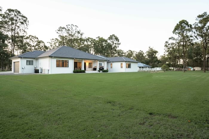 Exterior daytime view of the home and gardens