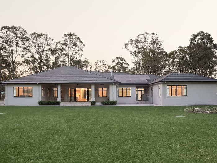 Rear of the home at dusk overlooking the lawn